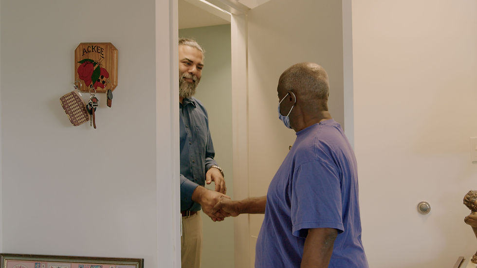                      Biren visiting a resident of St Hildas in their home.